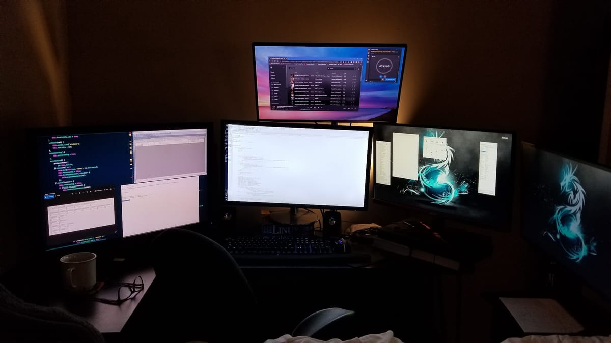 Developer workstation with multiple monitors showing code, terminals, and tools used while building an on-premise AI assistant in four days.
